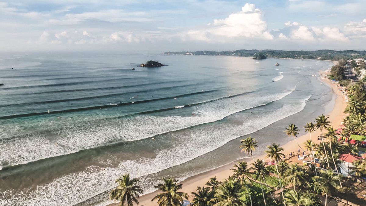 Sri Lankan surfing beach with waves and surfers
